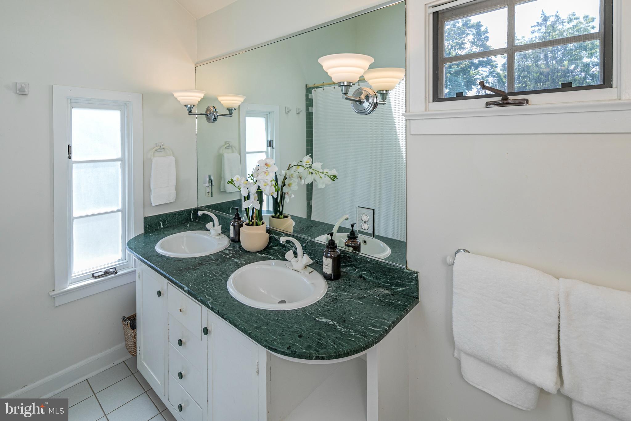 224 King George Road Pennington, NJ 08534 - Photo 34 of 58 a bathroom with a granite countertop sink and a mirror