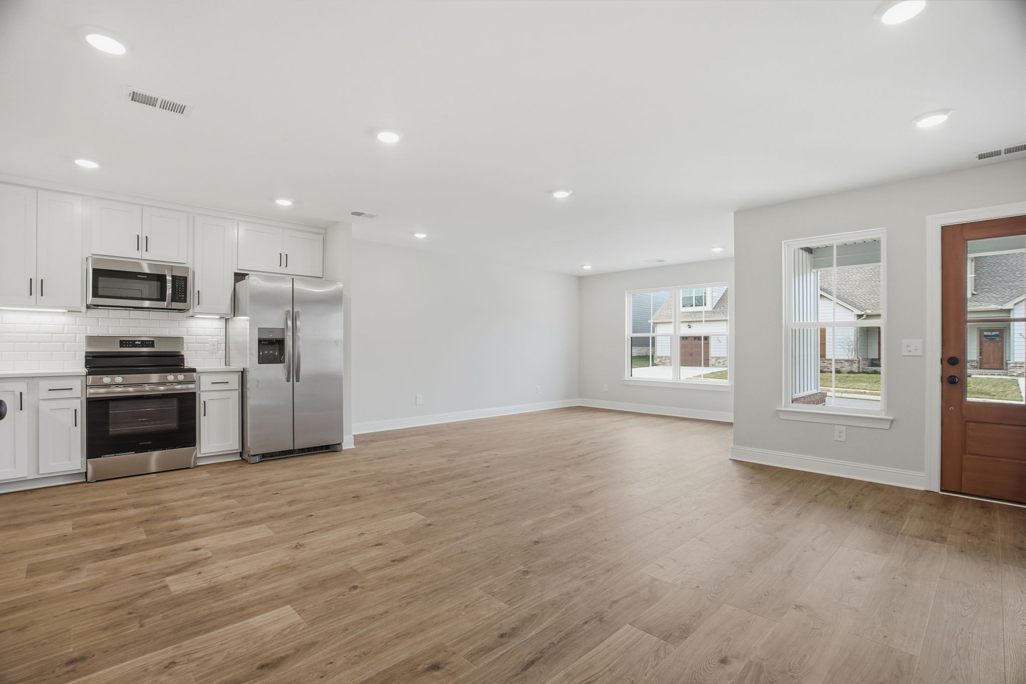 2145 Rylee Way, Unit 5 Greenbrier, TN 37073 - Photo 9 of 32 a view of kitchen with granite countertop a stove top oven a sink and dishwasher with wooden floor