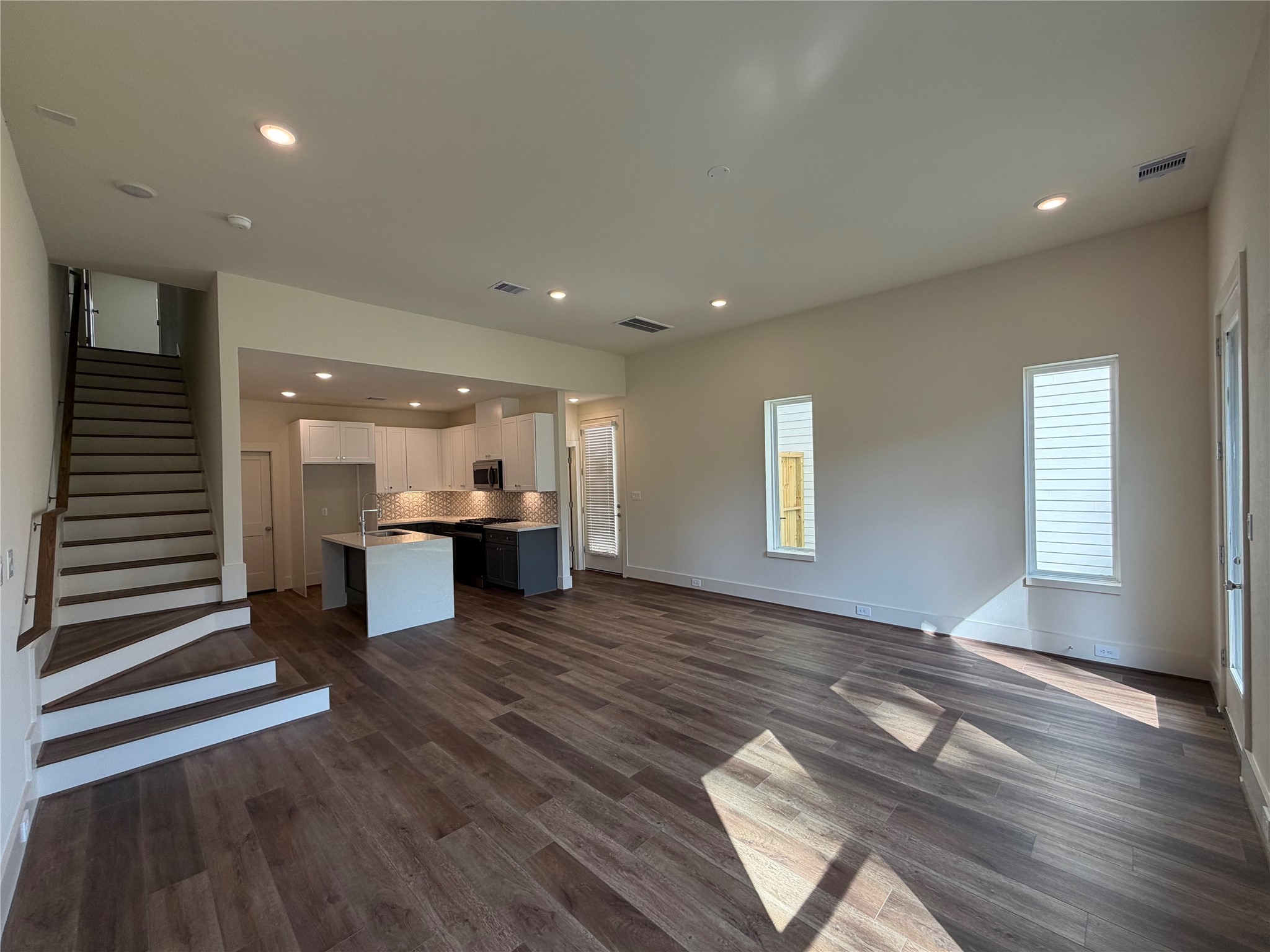879 Rachel Street, Unit E Houston, TX 77091 - Photo 13 of 34 a view of an empty room with window and wooden floor