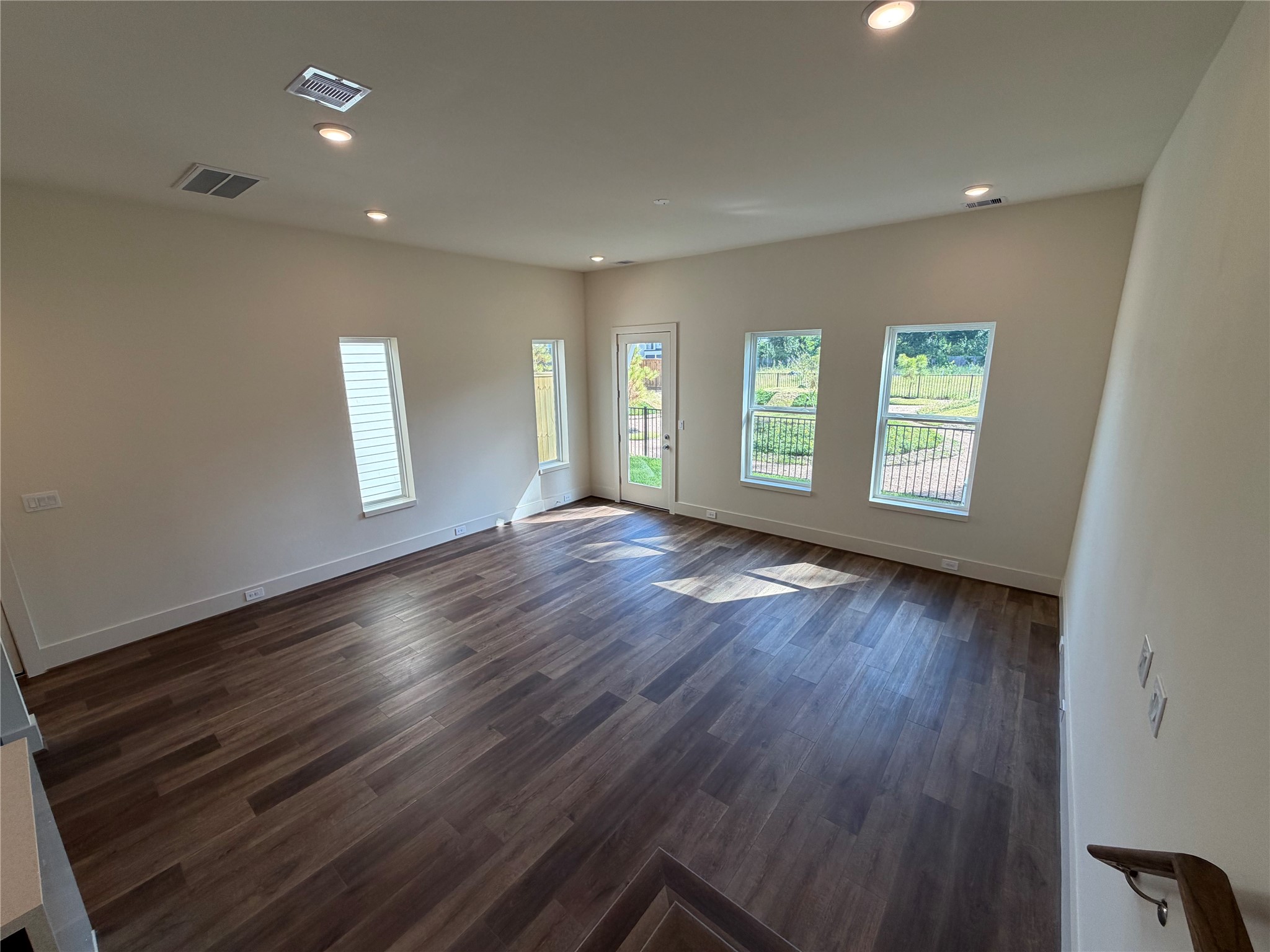 879 Rachel Street, Unit E Houston, TX 77091 - Photo 14 of 34 a view of an empty room with wooden floor and window