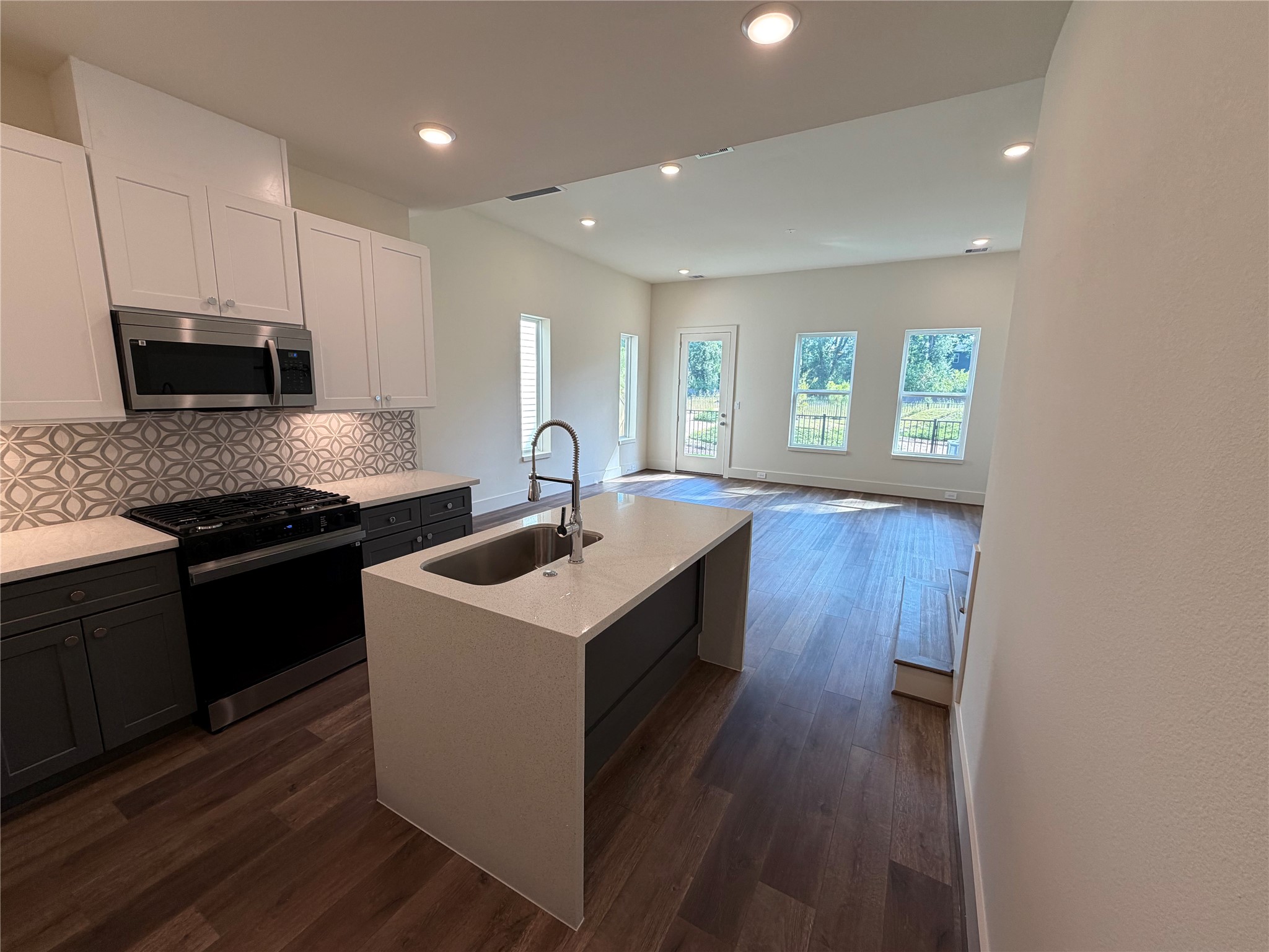 879 Rachel Street, Unit E Houston, TX 77091 - Photo 9 of 34 a kitchen with a sink stove and microwave