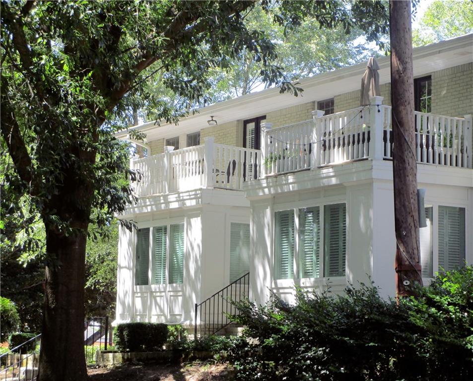 1879 Johnson Road Northeast, Unit 13 Atlanta, GA 30306 - Photo 1 of 1 a front view of a house with a tree