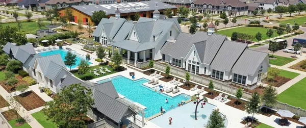 an aerial view of a house with a garden and lake view
