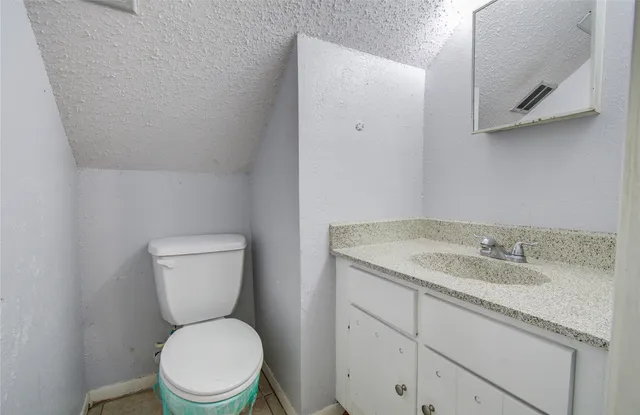 a white toilet sitting next to a bathroom sink