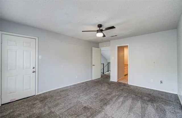 a view of a livingroom with a ceiling fan window and a ceiling fan