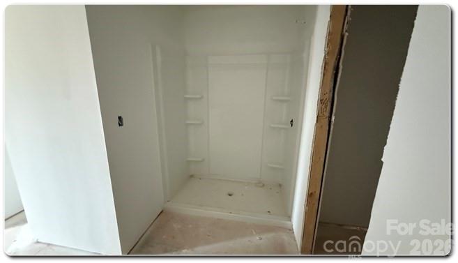 9472 Caddell Road Fort Mill, SC 29707 - Photo 7 of 17 a bathroom with a glass door shower