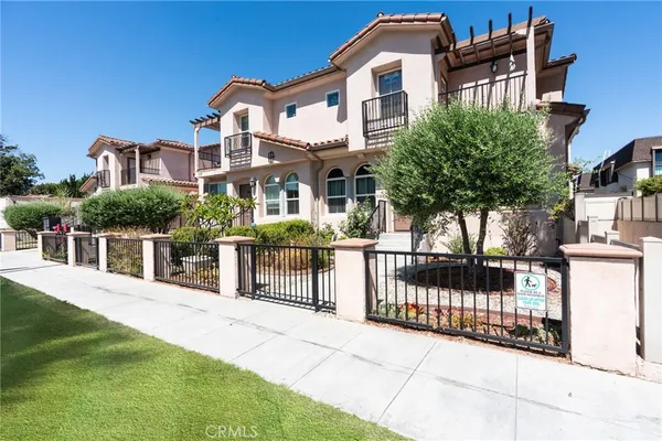 a front view of a house with iron fence