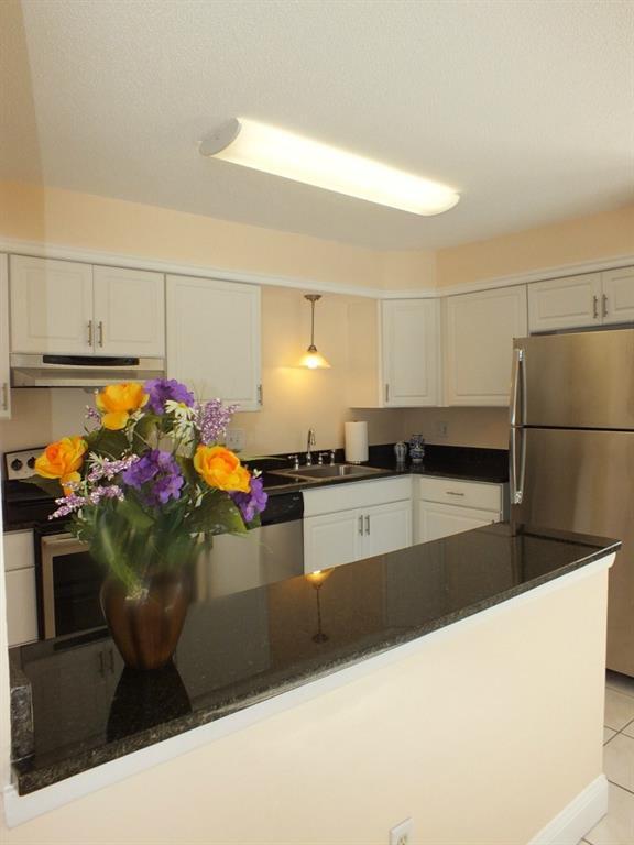 93 Kent Court, Unit 93 Meriden, CT 06450 - Photo 5 of 27 a kitchen with stainless steel appliances kitchen island granite countertop a sink and a stove