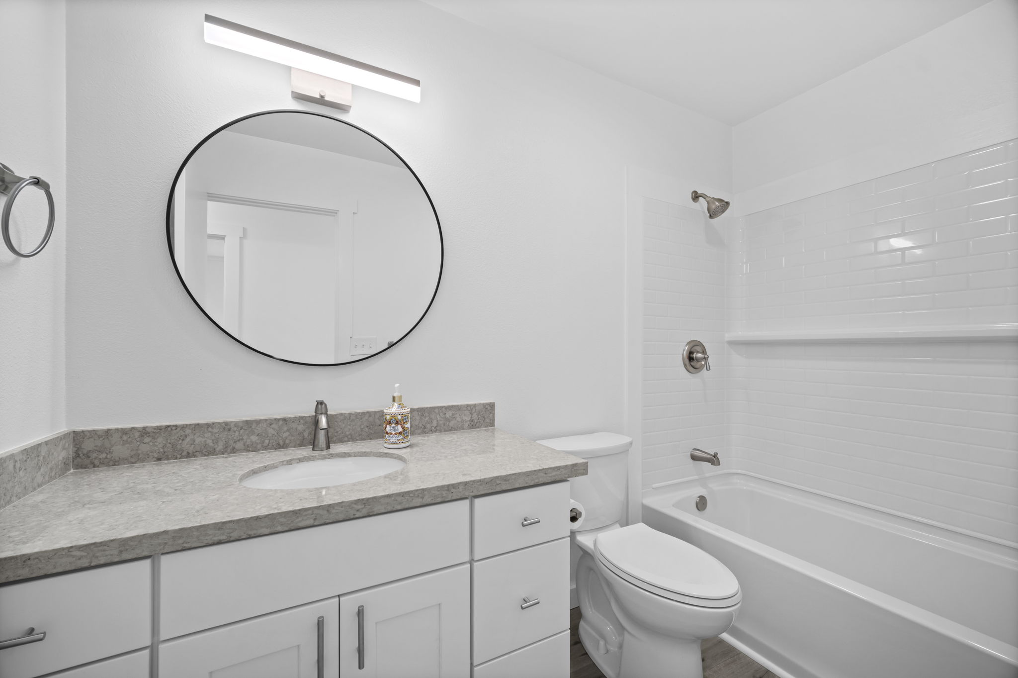 4431 Iona Road Hanapepe, HI 96705 - Photo 10 of 20 a bathroom with a granite countertop toilet a sink and a mirror