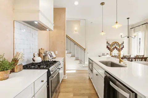 a kitchen with a sink stove and cabinets