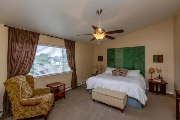 a bedroom with a bed and a chandelier