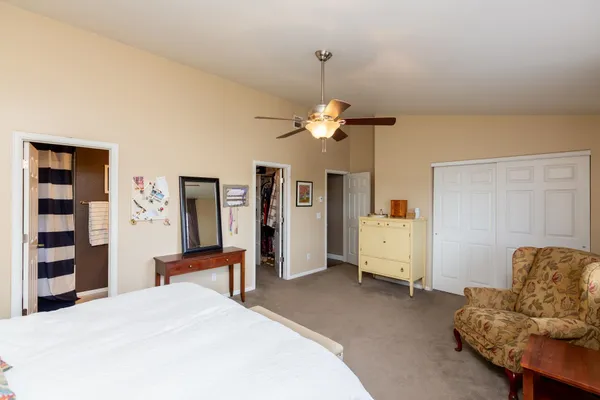 a spacious bedroom with a bed and furniture