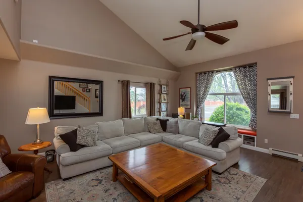 a living room with furniture a window and a chandelier