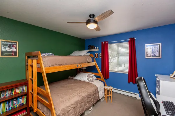 a bedroom with a bed and a bookshelf
