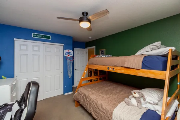 a bedroom with bed and a chandelier
