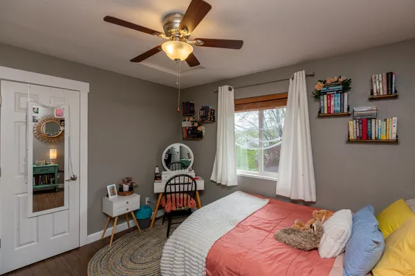 a bedroom with a bed and a window