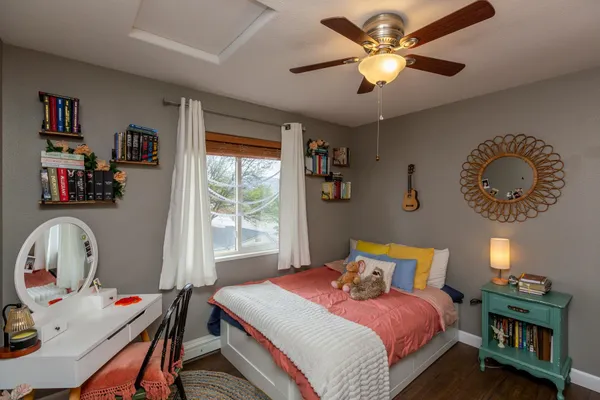 a bedroom with a bed and a chandelier