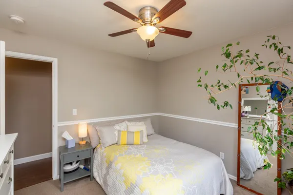 a bedroom with a bed and a potted plant
