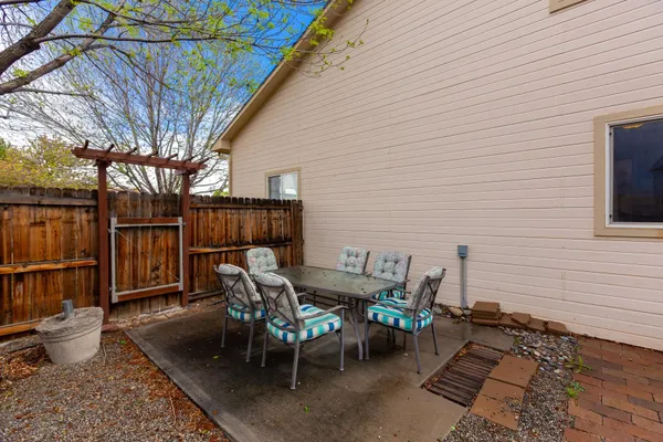 a backyard of a house with table and chairs