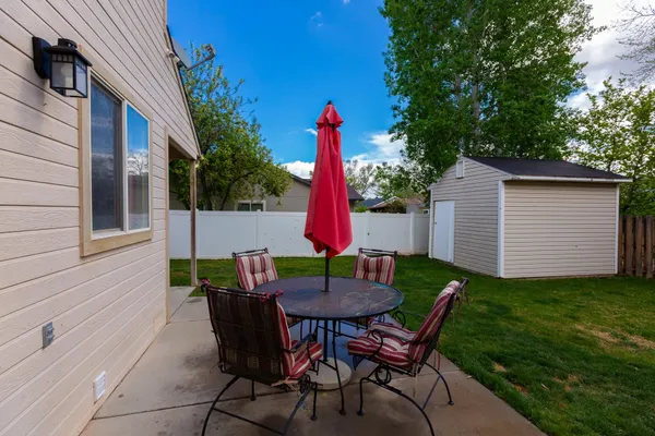 a backyard of a house with table and chairs
