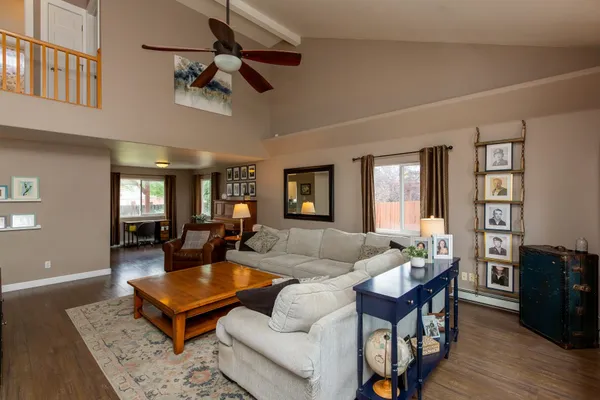 a living room with furniture a rug and a chandelier