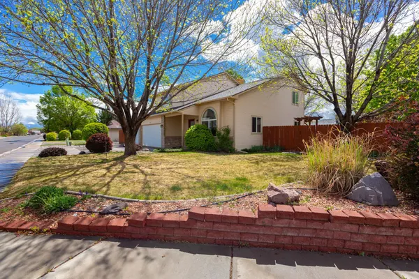 a wooden bench sitting in front of a house