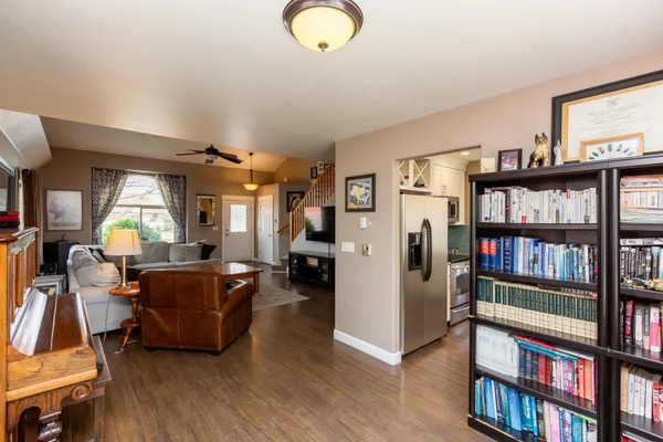 a living room with lots of furniture and a book shelf