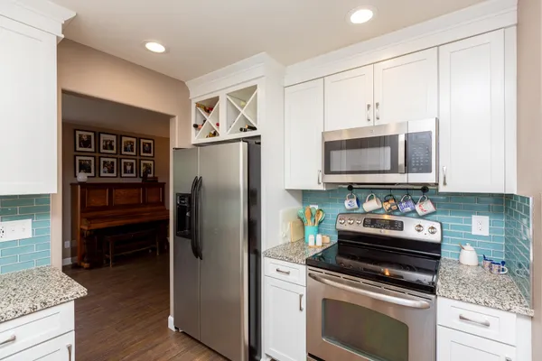 a kitchen with stainless steel appliances a refrigerator a stove and cabinets