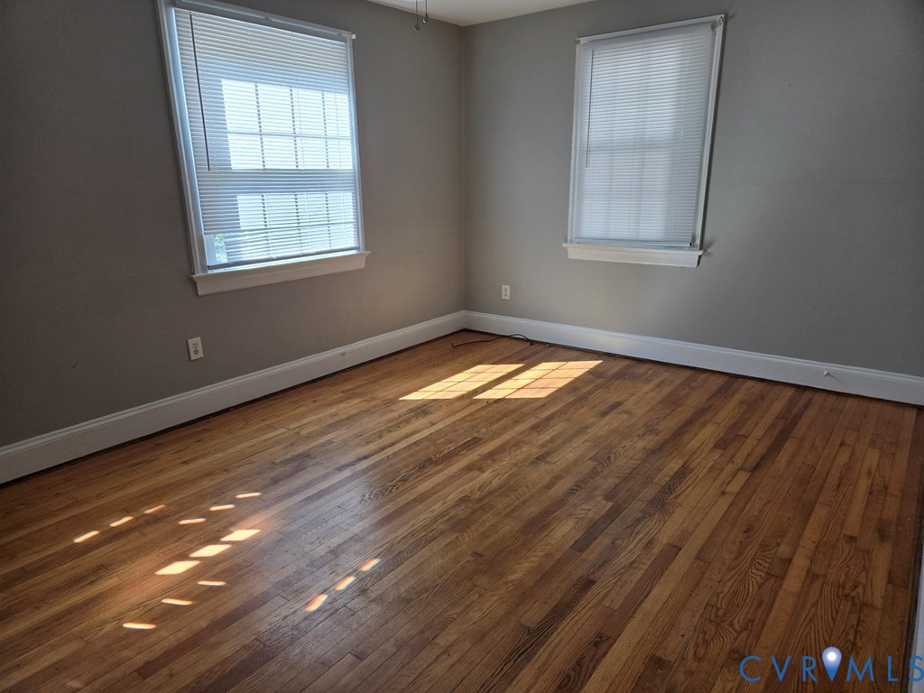 1546 Cumberland Road Farmville, VA 23901 - Photo 5 of 8 an empty room with wooden floor and windows