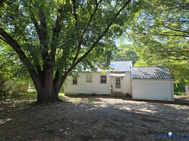 a view of house with backyard space and garden