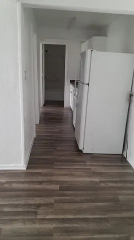 a view of a closet with wooden floor