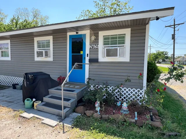 a view of a house with a yard and furniture