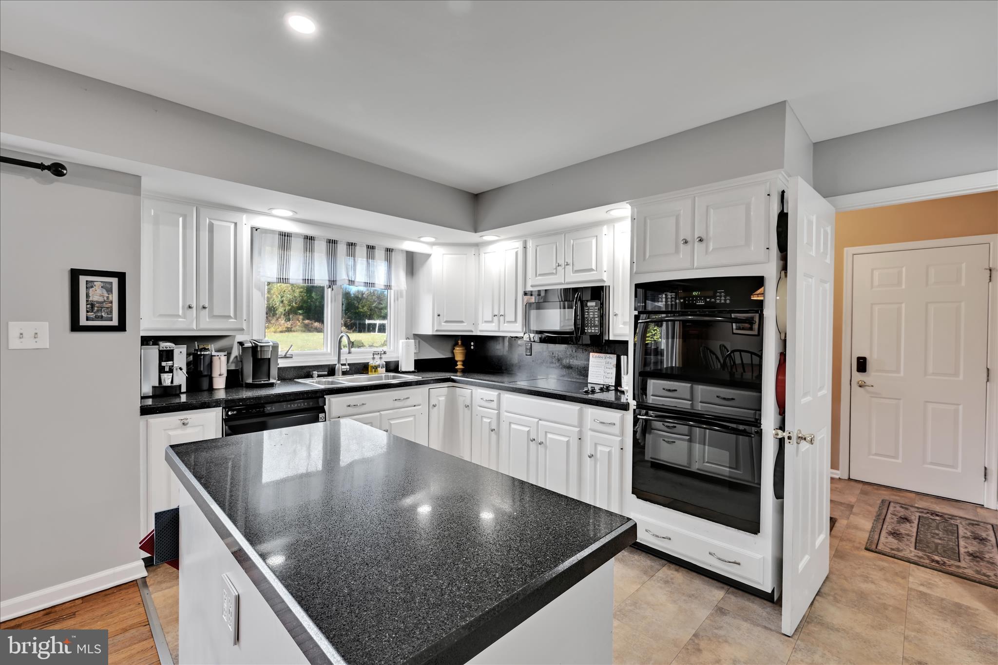 206 Marie Road West Chester, PA 19380 - Photo 16 of 51 a kitchen with stainless steel appliances granite countertop a sink a stove and cabinets