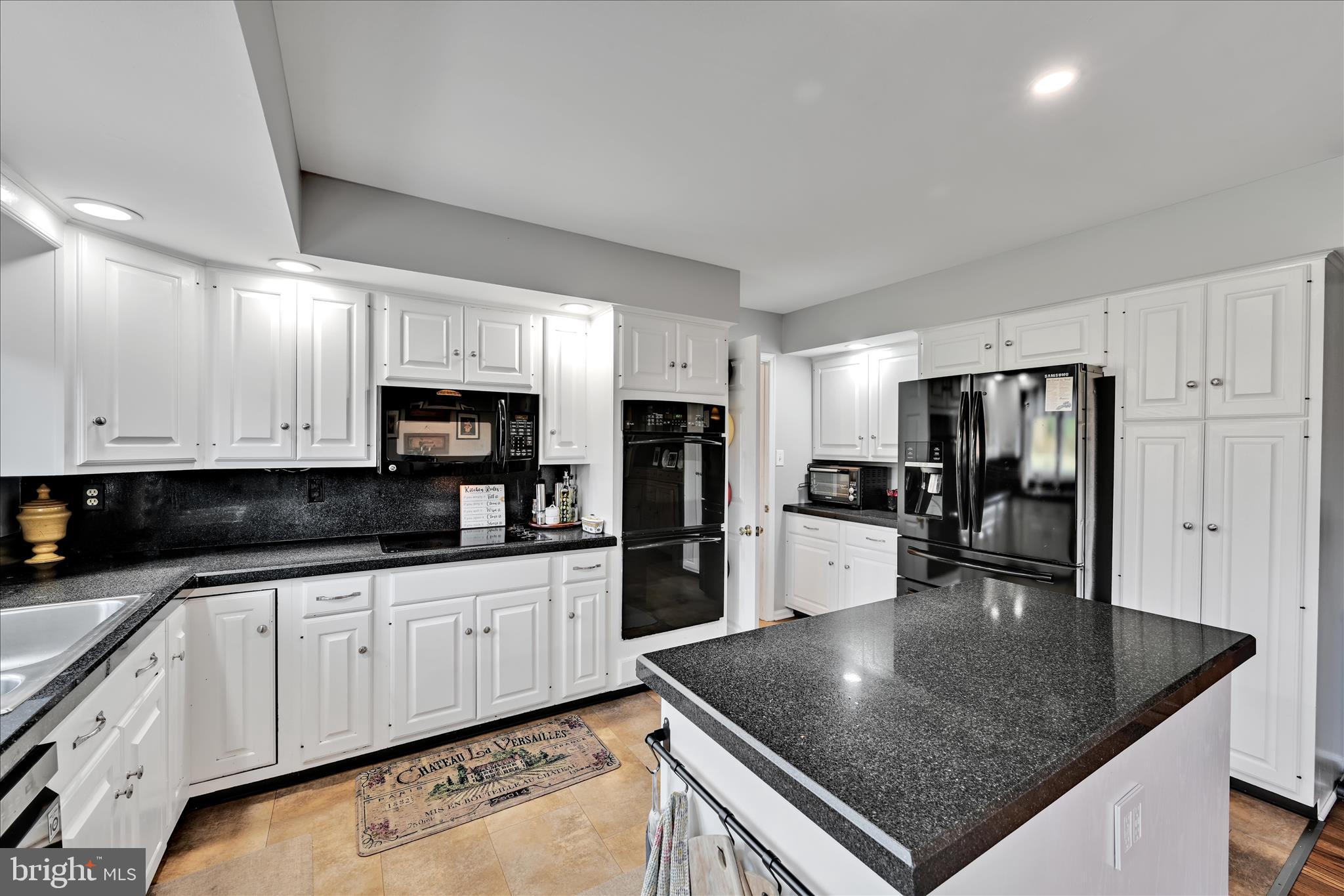 206 Marie Road West Chester, PA 19380 - Photo 17 of 51 a kitchen with stainless steel appliances granite countertop a sink a stove and refrigerator