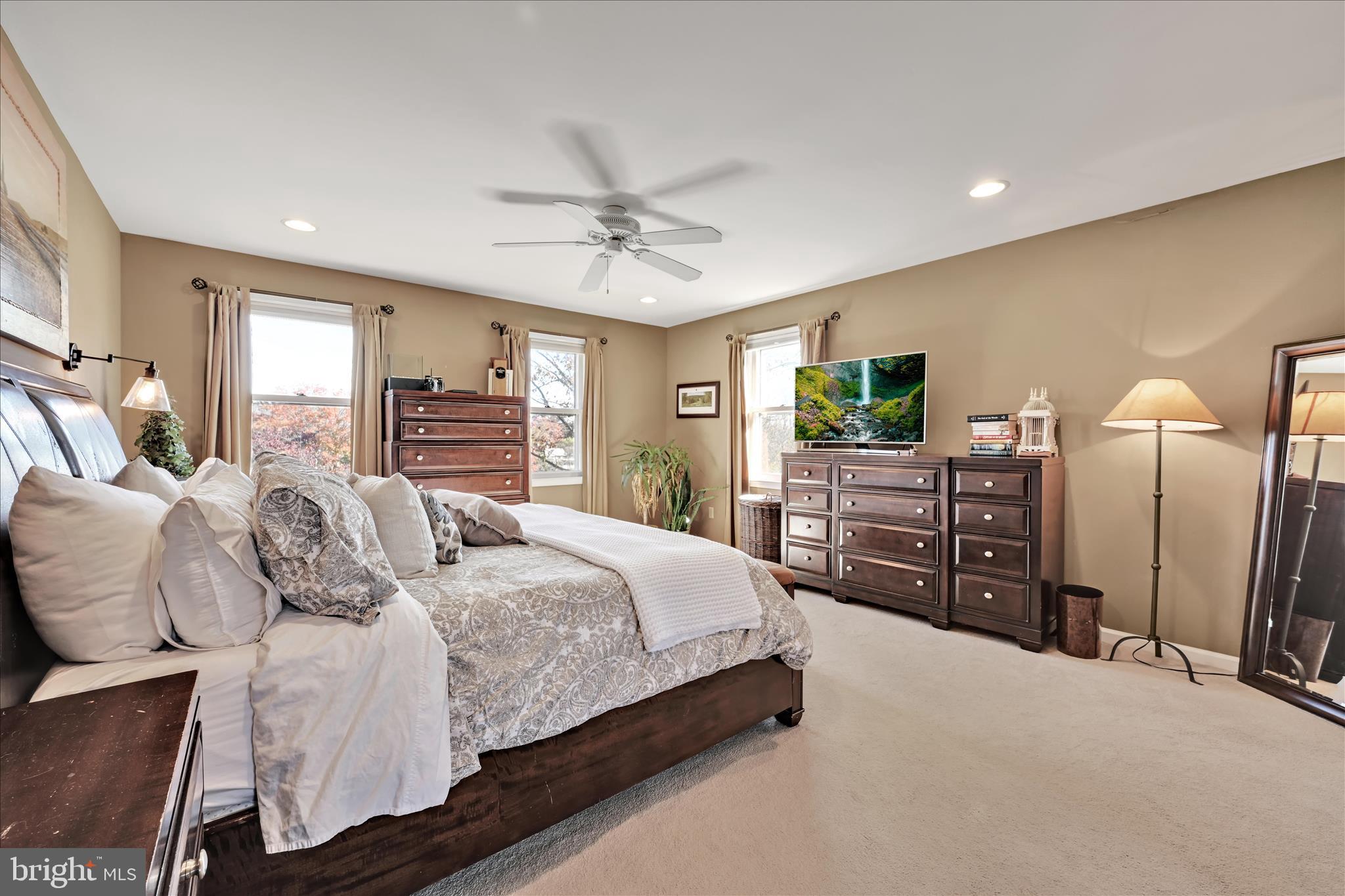 206 Marie Road West Chester, PA 19380 - Photo 21 of 51 a spacious bedroom with a bed a dresser and a flat screen television