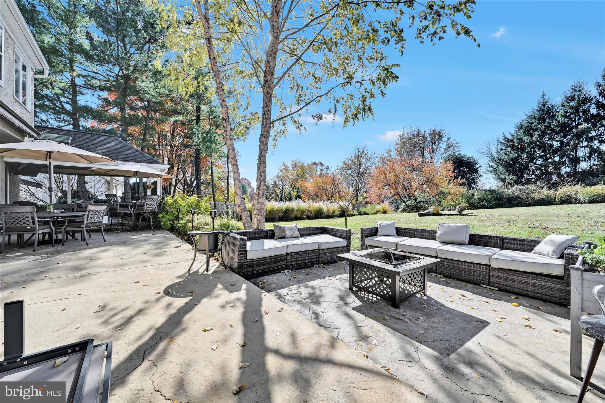 206 Marie Road West Chester, PA 19380 - Photo 42 of 51 a view of a patio with couches and a table and chairs under an umbrella