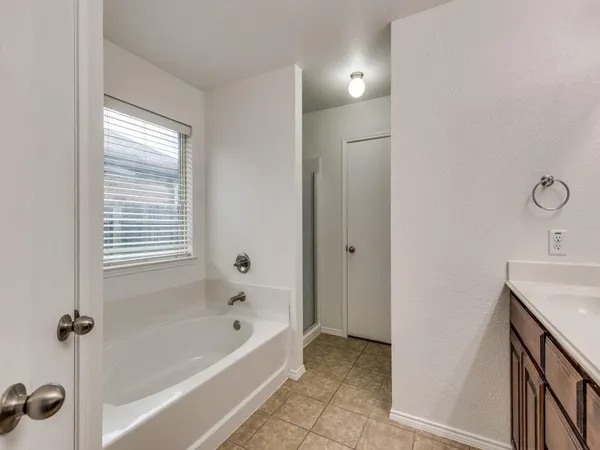 a bathroom with a bath tub and a shower