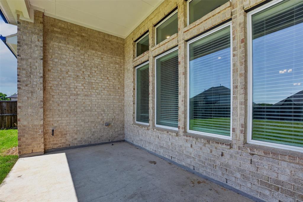 16812 Bitterroot Road Justin, TX 76247 - Photo 25 of 27 a view of a brick house with a large window