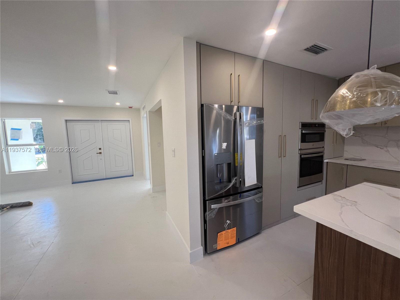 2315 Northwest 3rd Street Miami, FL 33125 - Photo 14 of 15 a kitchen with stainless steel appliances a refrigerator and a stove