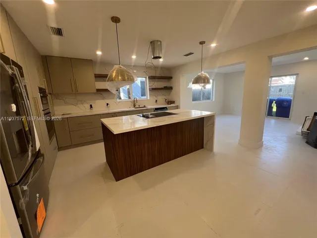 a kitchen with cabinets and wooden floor