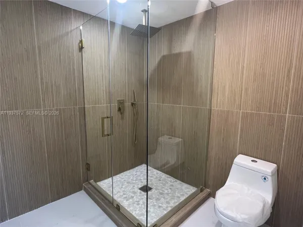 a bathroom with a shower and toilet