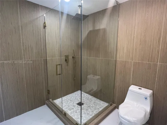 a bathroom with a shower and toilet