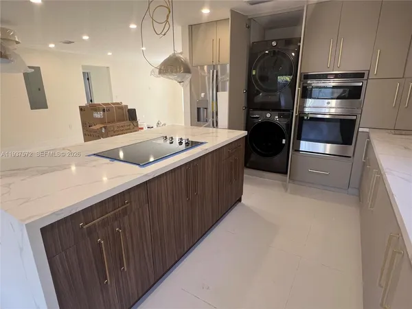 a kitchen with a sink and refrigerator