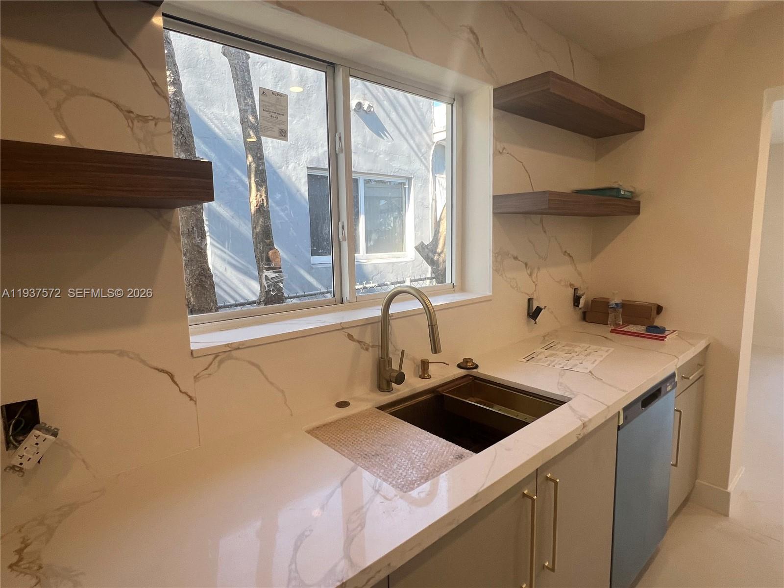 2315 Northwest 3rd Street Miami, FL 33125 - Photo 9 of 15 a utility room with a sink dryer and window