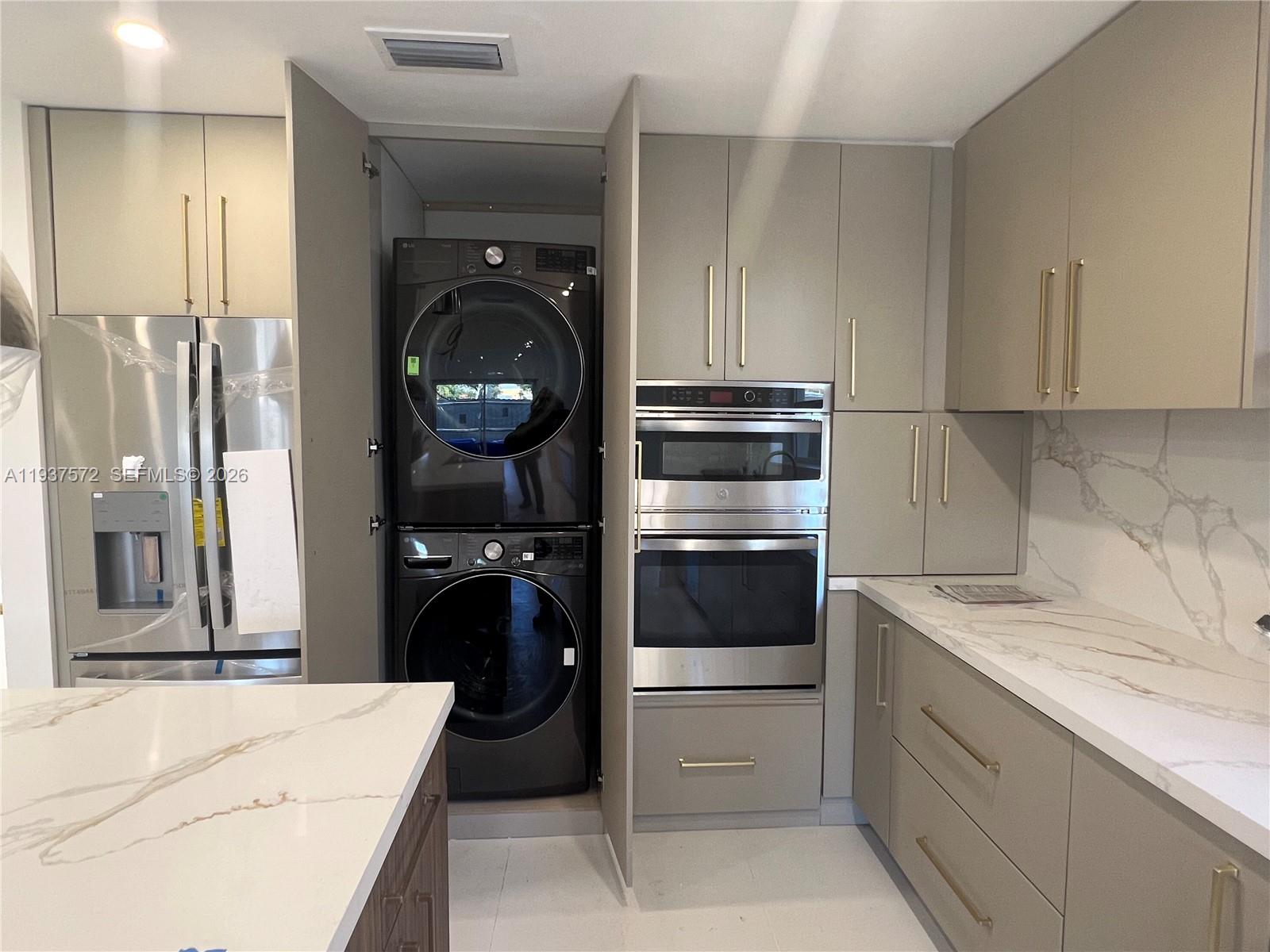 2315 Northwest 3rd Street Miami, FL 33125 - Photo 10 of 15 a kitchen with a refrigerator and a stove