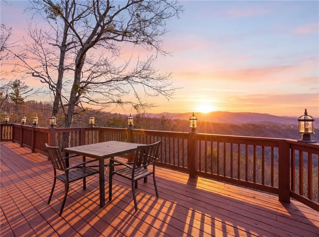 a view of a roof deck with table and chairs and wooden floor