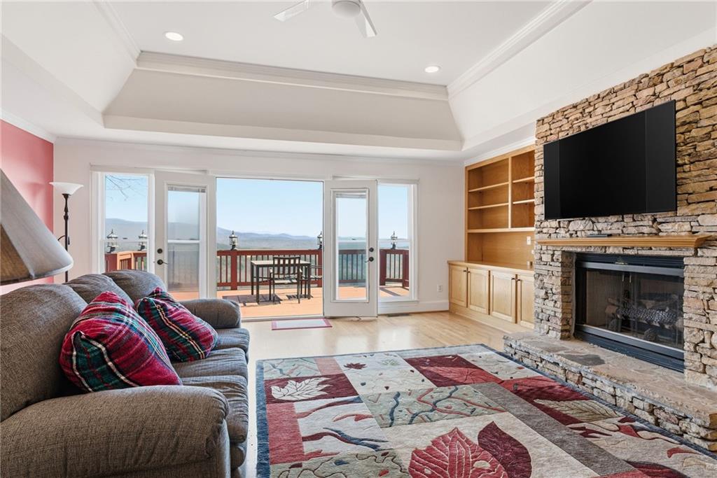 1015 Eagle Ridge Road Dawsonville, GA 30534 - Photo 15 of 64 a living room with furniture a flat screen tv and a fireplace