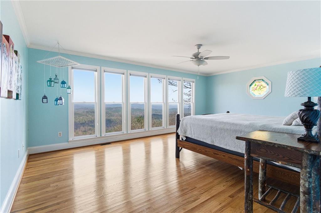 1015 Eagle Ridge Road Dawsonville, GA 30534 - Photo 22 of 64 a bedroom with a bed window and a table in it