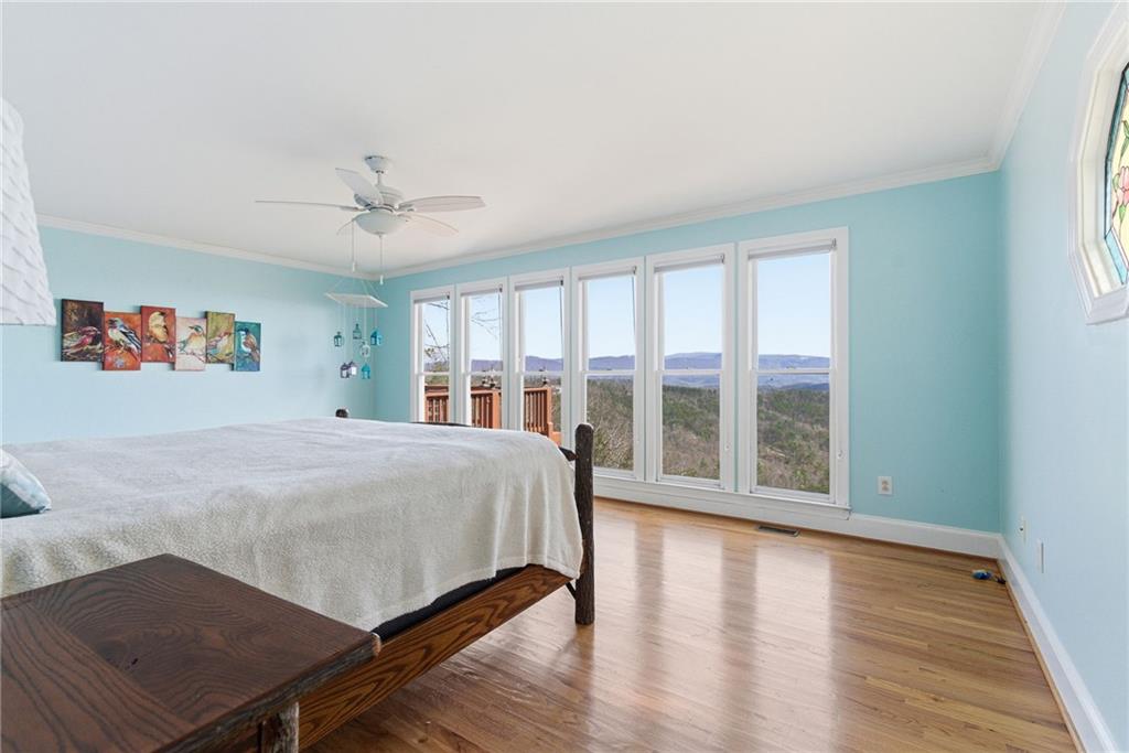 1015 Eagle Ridge Road Dawsonville, GA 30534 - Photo 23 of 64 a spacious bedroom with a large bed and a large window