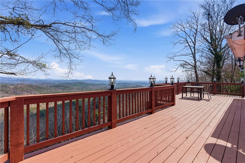 1015 Eagle Ridge Road Dawsonville, GA 30534 - Photo 5 of 64 a view of roof deck with wooden floor and fence